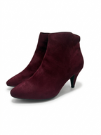 Pair of maroon ankle boots on a white background